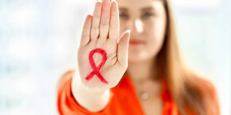 young woman showing hiv red loop drawn on hand 2021 12 14 18 47 29 utc 750x375 2 1